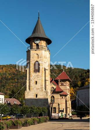 Medieval stone clock tower stands tall under clear Piatra Neamt sky Medieval stone clock tower stands tall under clear Piatra Neamt sky 134400867