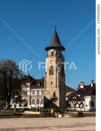 Medieval stone clock tower stands tall under clear Piatra Neamt sky 134400869