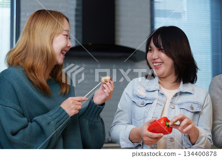 Cooking Party: Friends Enjoying Fun Cooking Session with Fresh Ingredients Cooking Party: Friends Enjoying Fun Cooking Session with Fresh Ingredients 134400878