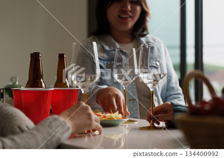 Party snacks and drinks shared among friends Party snacks and drinks shared among friends 134400992