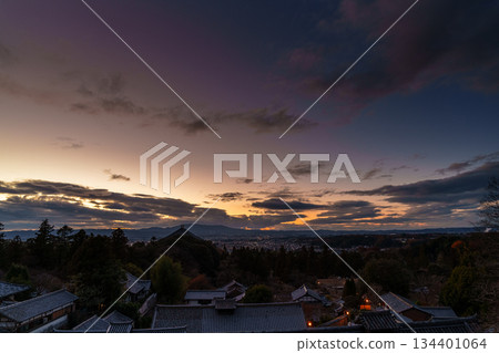 Nara in December: Sunset sky from Todaiji Temple's Nigatsudo Hall. A beautiful sunset sky that changes from golden to dark blue. 134401064
