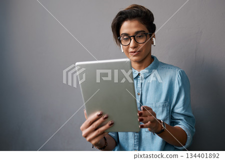 Tablet, music and young woman or student isolated on gray background for university e learning and online streaming. Creative gen z person on digital technology listening to audio on electronics app Tablet, music and young woman or student isolated on gray background for university e learning and online streaming. Creative gen z person on digital technology listening to audio on electronics app 134401892