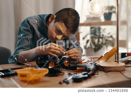 Education, car robot and kid in home with homework, homeschool and science, learning and tech project. Robotics, building and boy child with electrical knowledge, engineering and studying in house. Education, car robot and kid in home with homework, homeschool and science, learning and tech project. Robotics, building and boy child with electrical knowledge, engineering and studying in house. 134401898