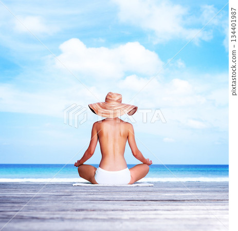 Travel, meditation and topless with woman at beach for sunbathing, summer and freedom in Bali. Relax, yoga and tropical with girl meditating in bikini on vacation for mockup, peace and beauty 134401987