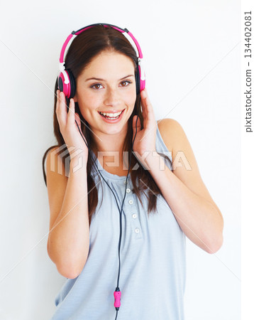 Music headphones, portrait and happy woman listening to fun girl song, wellness audio podcast or radio sound. Studio smile, freedom and gen z model streaming edm playlist isolated on white background Music headphones, portrait and happy woman listening to fun girl song, wellness audio podcast or radio sound. Studio smile, freedom and gen z model streaming edm playlist isolated on white background 134402081