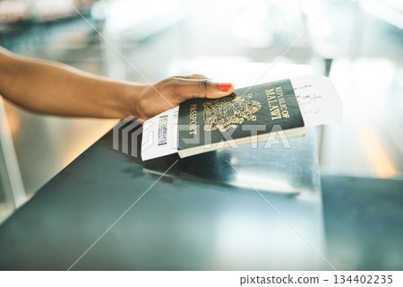 Hand, passport and airport service counter closeup or boarding flight, support and travel desk administration. Travelling tourist, checkin and person with id book, ticket and journey documents 134402235