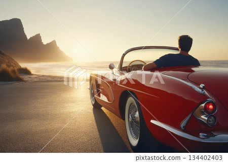 Classic Red Convertible Car at Sunset by the Beach with Man Admiring Scenic View 134402403