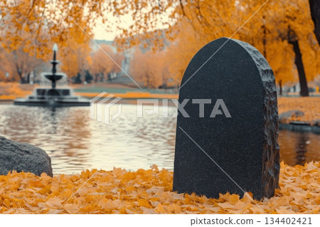 Serene Autumn Landscape with Leafy Ground and Quiet Water Fountain in Background Serene Autumn Landscape with Leafy Ground and Quiet Water Fountain in Background 134402421