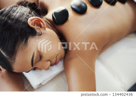 Woman, relax and sleeping in rock massage at spa for skincare, beauty or body treatment at salon. Calm female asleep with eyes closed and hot rocks on back for healthy physical therapy at the resort Woman, relax and sleeping in rock massage at spa for skincare, beauty or body treatment at salon. Calm female asleep with eyes closed and hot rocks on back for healthy physical therapy at the resort 134402436