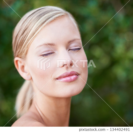 Beauty, makeup and face of a woman outdoor in nature for natural cosmetics, dermatology and glow. Female model person happy with green or sustainable skincare, self care and healthy facial skin 134402491