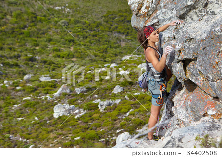 Rock climbing, freedom and challenge with woman on mountain for adventure, travel and explore. Strong, fitness and cliff with female climber training in nature for courage, safety and workout Rock climbing, freedom and challenge with woman on mountain for adventure, travel and explore. Strong, fitness and cliff with female climber training in nature for courage, safety and workout 134402508