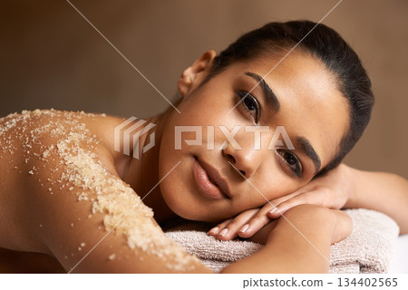 Portrait, body scrub or massage for woman to relax for resting or wellness physical therapy in spa. Face of calm girl client in beauty salon to exfoliate for a healthy skincare healing treatment 134402565