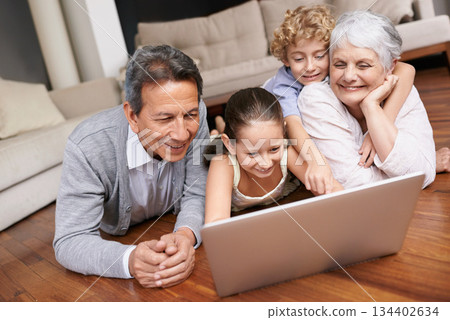 Laptop, floor or grandparents with happy kids for movie streaming online subscription in retirement at home. Children siblings, relax or grandmother watching videos on internet with a senior old man Laptop, floor or grandparents with happy kids for movie streaming online subscription in retirement at home. Children siblings, relax or grandmother watching videos on internet with a senior old man 134402634