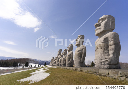 Moai, big stone statue in winter with snow on ground at hill of Buddha in Sapporo, Makomanai takino Moai, big stone statue in winter with snow on ground at hill of Buddha in Sapporo, Makomanai takino 134402778