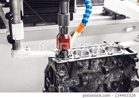 Work of CNC machine for honing to reduce the roughness of the engine cylinder walls. Diamond boring of car details on Computer Numerical Control machine. 134403326