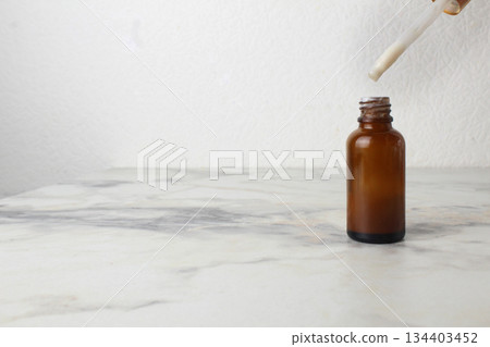 Medicine in a brown bottle with a pipette dispenser. Space for copyspace text. Medicine in a brown bottle with a pipette dispenser. Space for copyspace text. 134403452