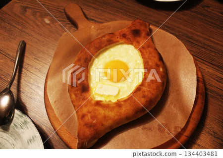 Georgian national dish Adjarian khachapuri dough boat with cheese and egg. 134403481