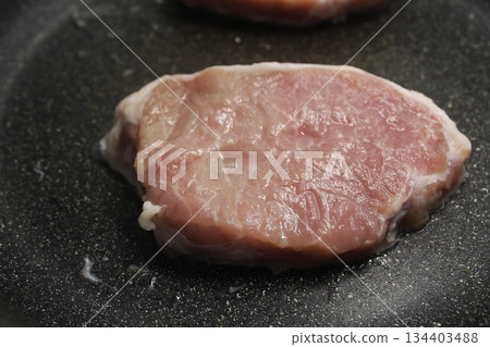 Piece of raw pork beef close-up view from above. 134403488