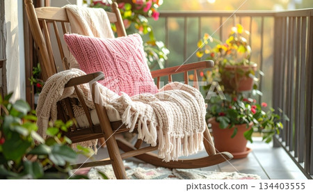Knitted Yarn Pillow and Blanket on Wooden Chair of Front Porch with Plants, Cozy Style 134403555