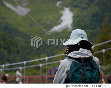 Tourists taking photos along the Azusa River in Kamikochi, a popular tourist spot Tourists taking photos along the Azusa River in Kamikochi, a popular tourist spot 134403928