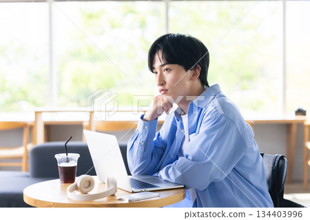 A man working at a cafe A man working at a cafe 134403996