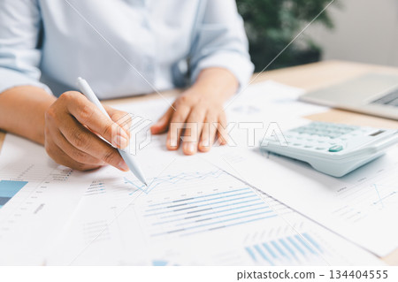 Business professional analyzing financial charts, performance graphs paper, illustrating data review, corporate planning accounting workflow strategic decision-making financial performance evaluation 134404555