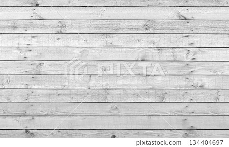 A close-up of a rustic wooden white plank wall showcasing grain patterns A close-up of a rustic wooden white plank wall showcasing grain patterns 134404697