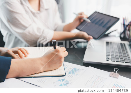 Business meeting, data analytics or women with graph presentation in office. Chart, analysis accounting team brainstorming economy, inflation or solution. business project finance investment concept. 134404789