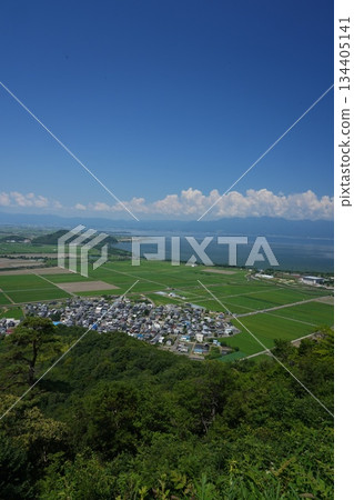 A bird's-eye view of the rice paddy fields on the lake shore and the blue sky from Mt. Yawata in summer, copy space 134405141