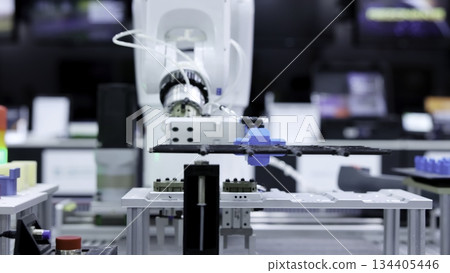 Robotic arm moving object in modern factory. Media Robotic arm moving object in modern factory. Media 134405446
