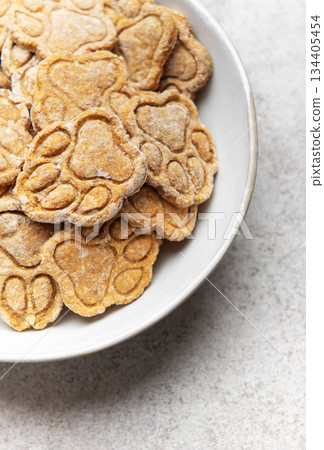 Homemade dog treats with paw print shape 134405454
