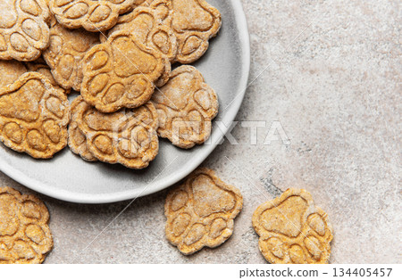 Homemade paw print dog treats on a plate Homemade paw print dog treats on a plate 134405457