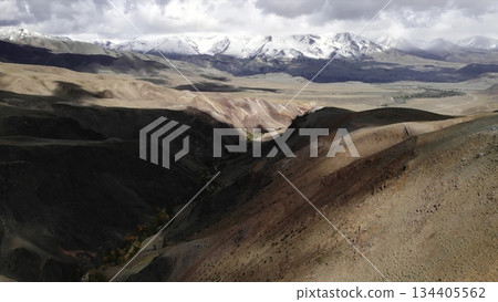 Clouds passing over colorful canyon and snowy mountains. Media Clouds passing over colorful canyon and snowy mountains. Media 134405562