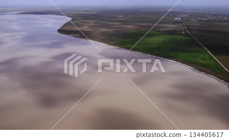 Aerial view of pink salt lake shoreline. Media Aerial view of pink salt lake shoreline. Media 134405617