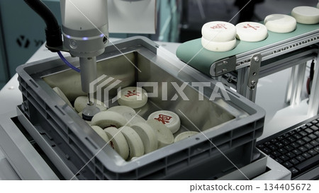 Robotic arm moving mahjong tiles on conveyor belt. Media 134405672