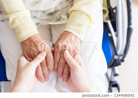 Woman holding senior woman's hand Woman holding senior woman's hand 134406091