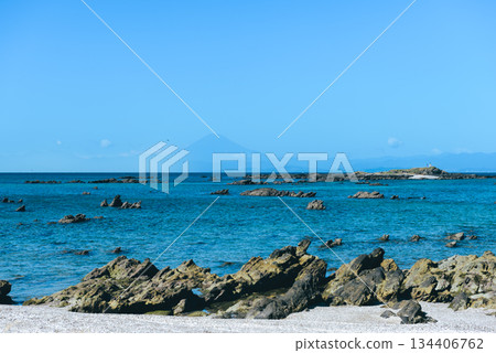 A landscape with a rocky coastline, blue sea, and Mount Fuji in the distance A landscape with a rocky coastline, blue sea, and Mount Fuji in the distance 134406762