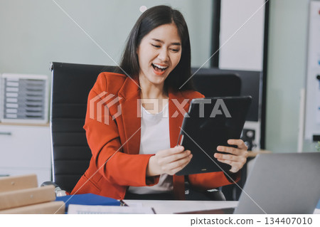 Beautiful young woman working using touchpad tablet Beautiful young woman working using touchpad tablet 134407010