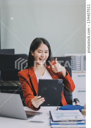 Beautiful young woman working using touchpad tablet Beautiful young woman working using touchpad tablet 134407011