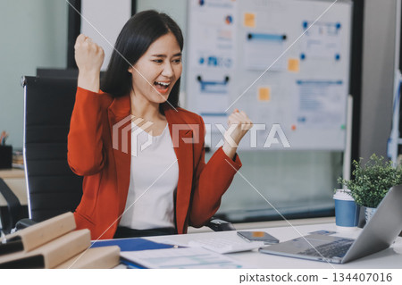 Asian business woman working on a laptop in a professional office 134407016