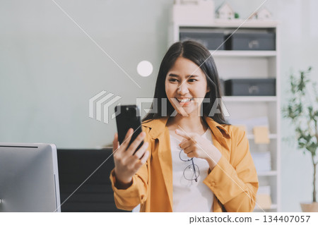 Business woman using calculator for do math finance on wooden desk in office and business working background, tax, accounting, statistics and analytic research concept. 134407057