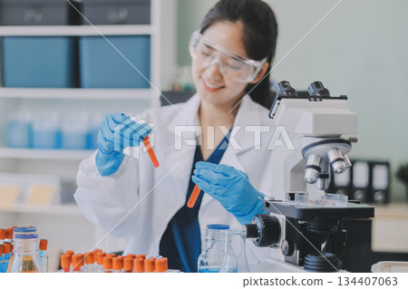Portrait, science and happy woman on laptop in lab to research chemistry, test or innovation. Microscope, scientist and face of medical doctor in goggles for microbiology, healthcare or pharma study Portrait, science and happy woman on laptop in lab to research chemistry, test or innovation. Microscope, scientist and face of medical doctor in goggles for microbiology, healthcare or pharma study 134407063