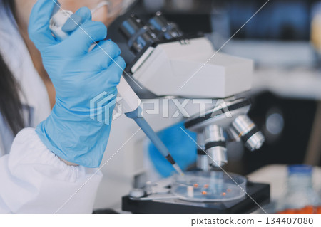 Portrait, science and happy woman on laptop in lab to research chemistry, test or innovation. Microscope, scientist and face of medical doctor in goggles for microbiology, healthcare or pharma study 134407080