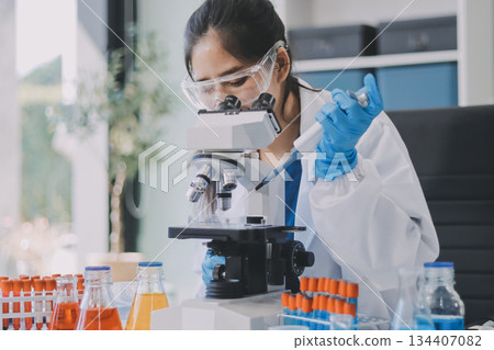 Portrait, science and happy woman on laptop in lab to research chemistry, test or innovation. Microscope, scientist and face of medical doctor in goggles for microbiology, healthcare or pharma study Portrait, science and happy woman on laptop in lab to research chemistry, test or innovation. Microscope, scientist and face of medical doctor in goggles for microbiology, healthcare or pharma study 134407082