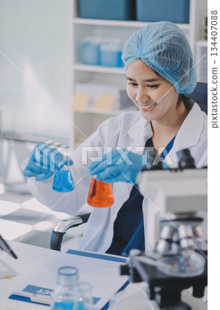 Portrait, science and happy woman on laptop in lab to research chemistry, test or innovation. Microscope, scientist and face of medical doctor in goggles for microbiology, healthcare or pharma study 134407088