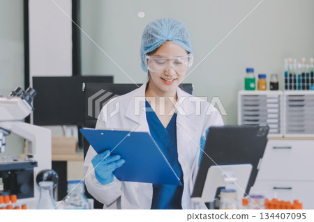 Portrait, science and happy woman on laptop in lab to research chemistry, test or innovation. Microscope, scientist and face of medical doctor in goggles for microbiology, healthcare or pharma study Portrait, science and happy woman on laptop in lab to research chemistry, test or innovation. Microscope, scientist and face of medical doctor in goggles for microbiology, healthcare or pharma study 134407095