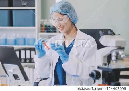 Portrait, science and happy woman on laptop in lab to research chemistry, test or innovation. Microscope, scientist and face of medical doctor in goggles for microbiology, healthcare or pharma study Portrait, science and happy woman on laptop in lab to research chemistry, test or innovation. Microscope, scientist and face of medical doctor in goggles for microbiology, healthcare or pharma study 134407096