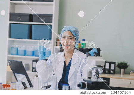 Portrait, science and happy woman on laptop in lab to research chemistry, test or innovation. Microscope, scientist and face of medical doctor in goggles for microbiology, healthcare or pharma study Portrait, science and happy woman on laptop in lab to research chemistry, test or innovation. Microscope, scientist and face of medical doctor in goggles for microbiology, healthcare or pharma study 134407104