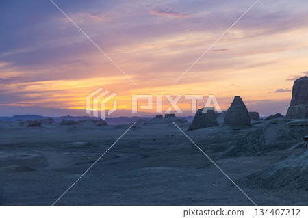 Xinjiang, China: Demon City: Desert wind-eroded rock formations bathed in the setting sun 134407212