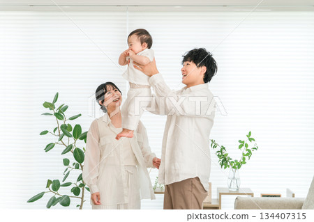 Young Asian couple holding a baby at home, family, parent and child, family 134407315